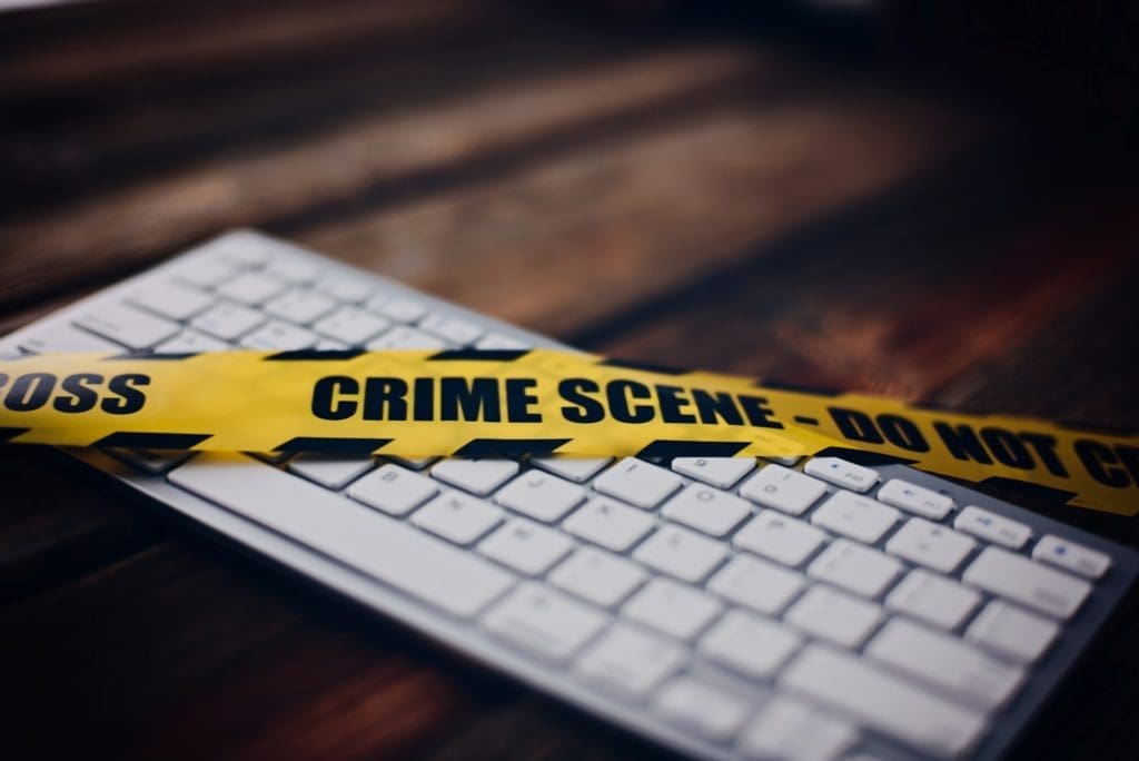 Possession of child pornography Crime scene tape over a computer keyboard for pornography