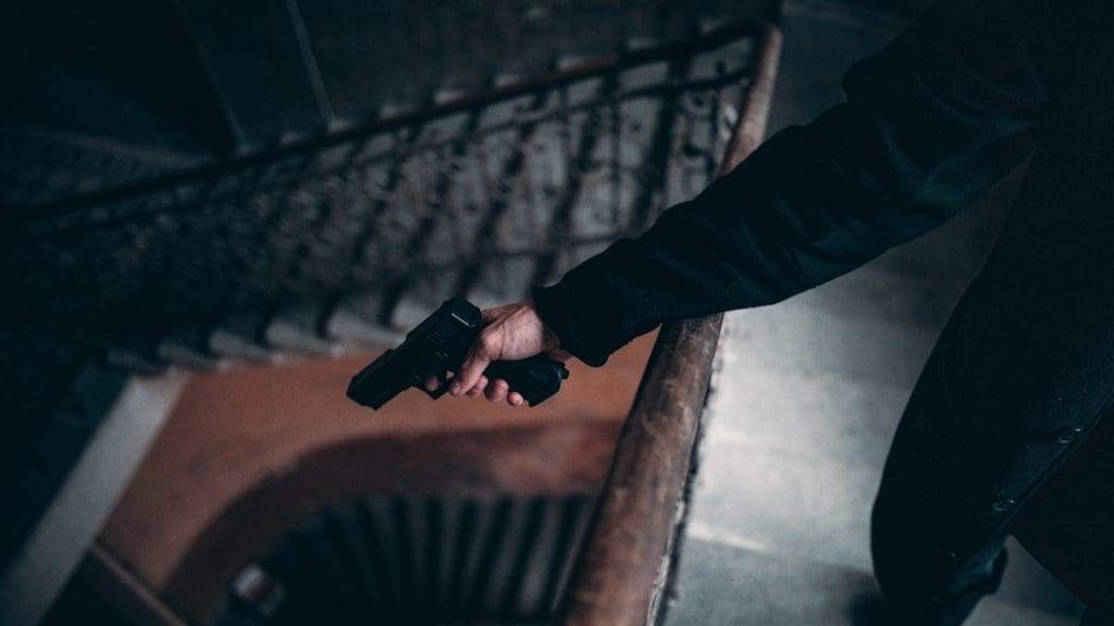 a man points a firearm at the victim. He will need firearm crime defense.