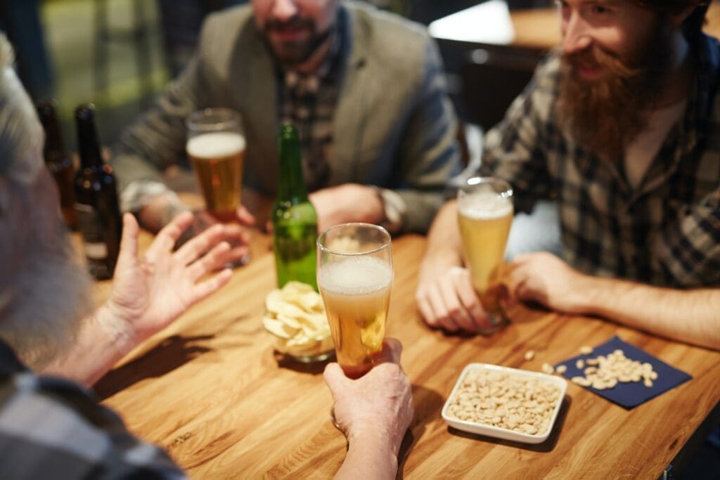 A group of men drink beer before driving home