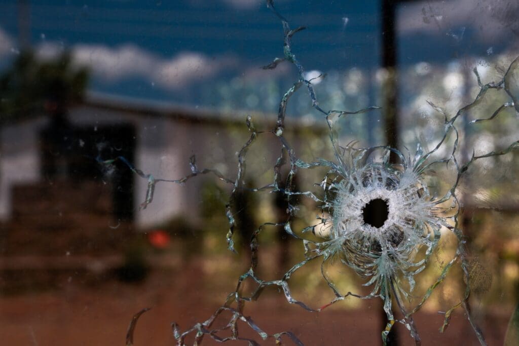 A house with a bullet hole through the glass