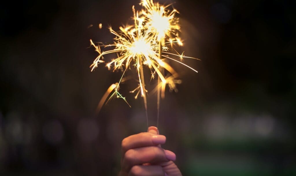 A person holds a sparkler