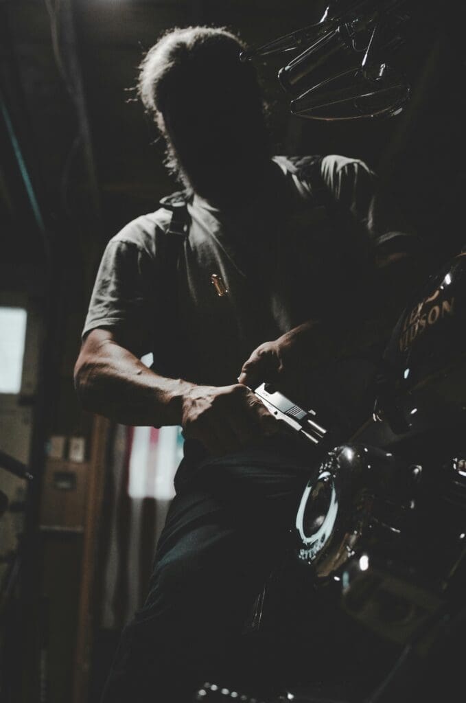 A man unloads a firearm in his garage.