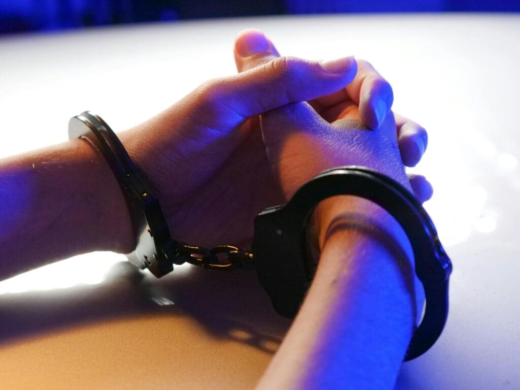 succeed on probation A man is handcuffed at a table