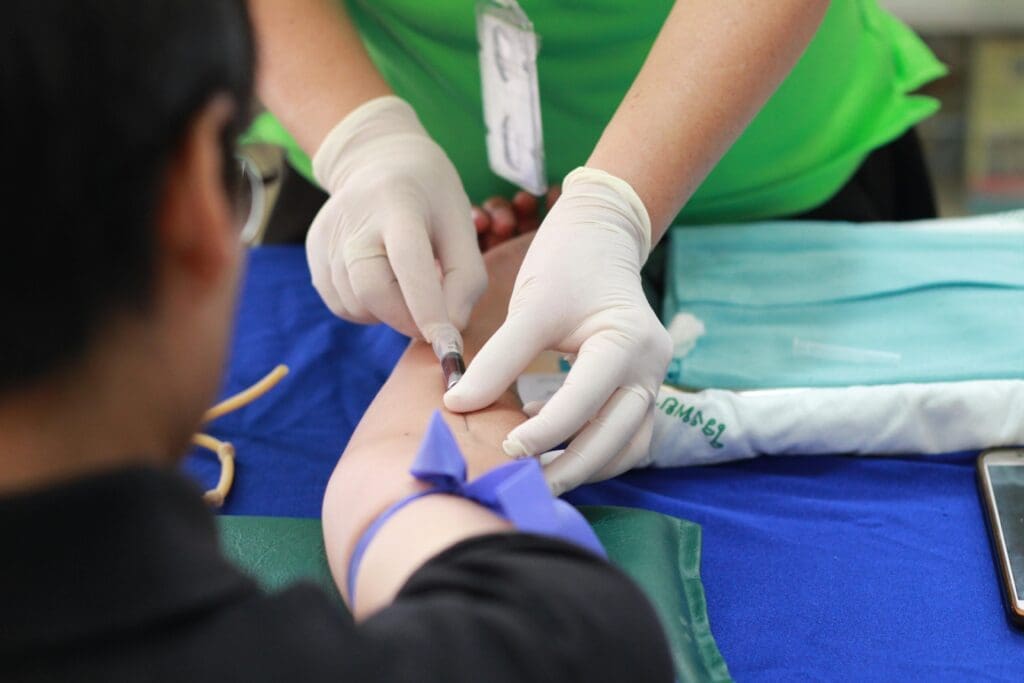 A nurse works on a patient